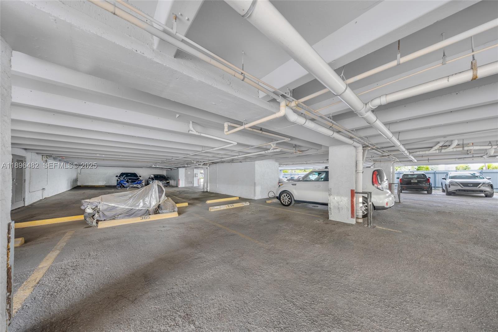 6545 Indian Creek Drive, Unit 504 Miami Beach, FL 33141 - Photo 28 of 38 a view of parking garage with cars