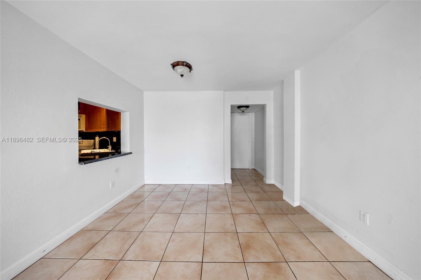 6545 Indian Creek Drive, Unit 504 Miami Beach, FL 33141 - Photo 8 of 38 a view of a livingroom with an empty space and a window