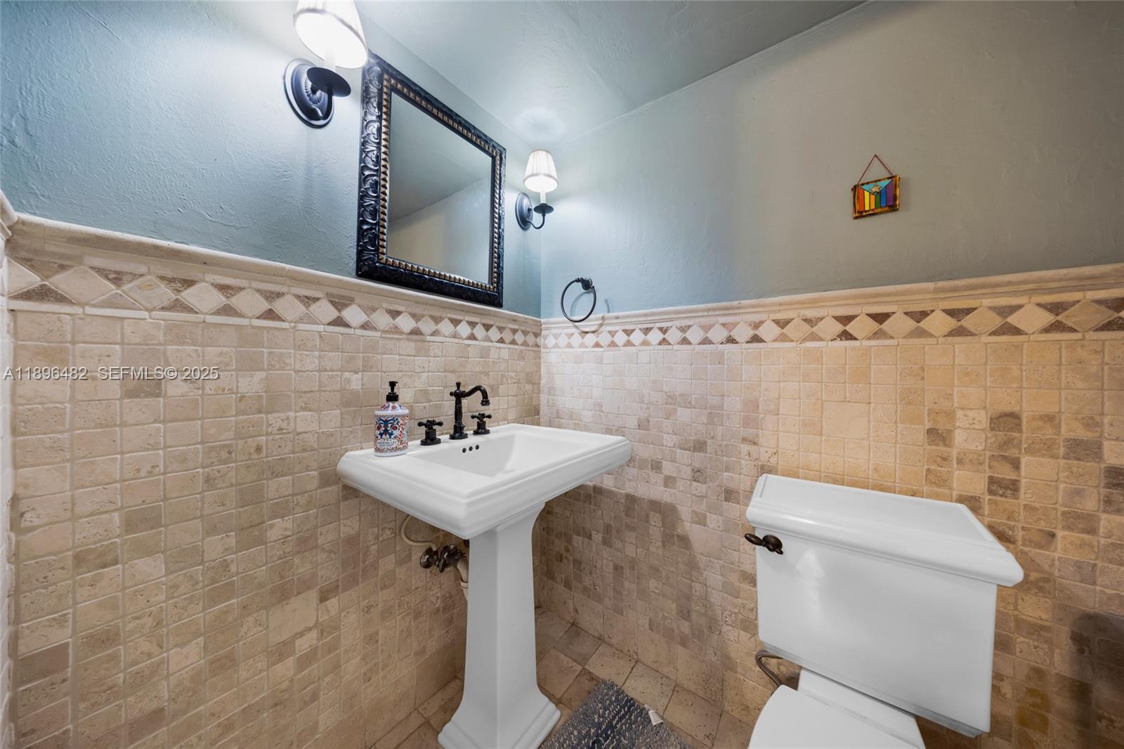 6545 Indian Creek Drive, Unit 504 Miami Beach, FL 33141 - Photo 10 of 38 a bathroom with a sink toilet and mirror
