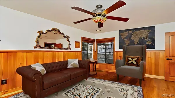 a living room with furniture and wooden floor
