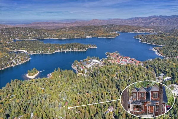 an aerial view of a house with a lake view