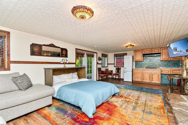 a bed room with a bed and a tv