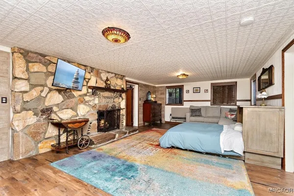 a kitchen with stainless steel appliances granite countertop a refrigerator and a fireplace