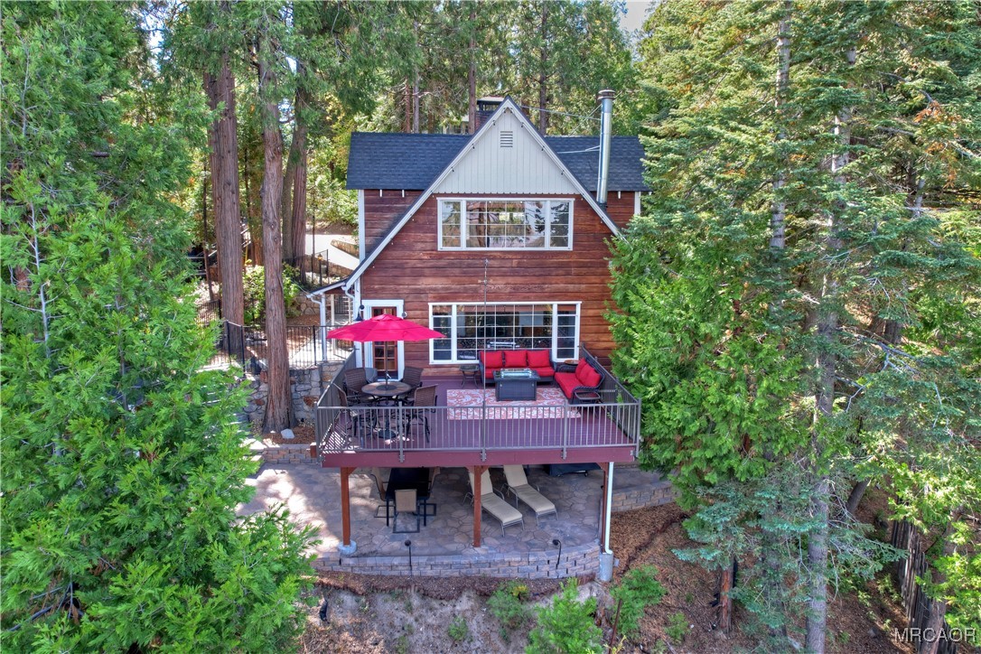 329 Summit Road Lake Arrowhead, CA 92352 - Photo 50 of 50 a view of a wooden chairs and table in a backyard