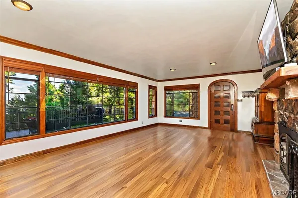 a view of a livingroom with wooden floor and furniture
