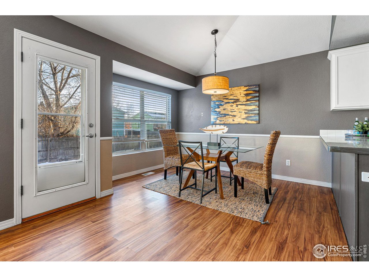 628 Sumac Street Frederick, CO 80530 - Photo 13 of 38 a view of a dining room with furniture window and wooden floor
