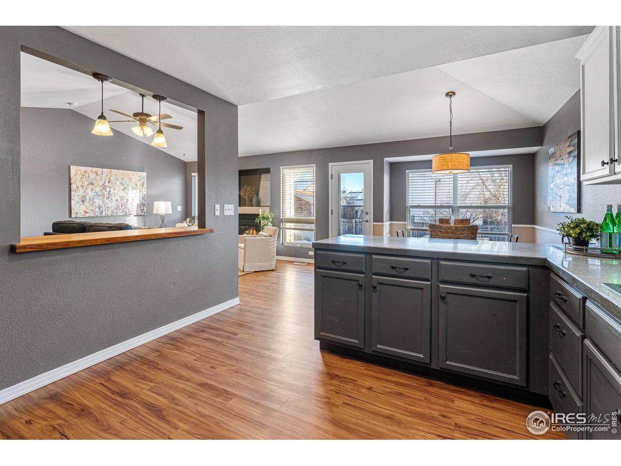 628 Sumac Street Frederick, CO 80530 - Photo 18 of 38 a kitchen with stainless steel appliances granite countertop a sink dishwasher a stove with wooden cabinets