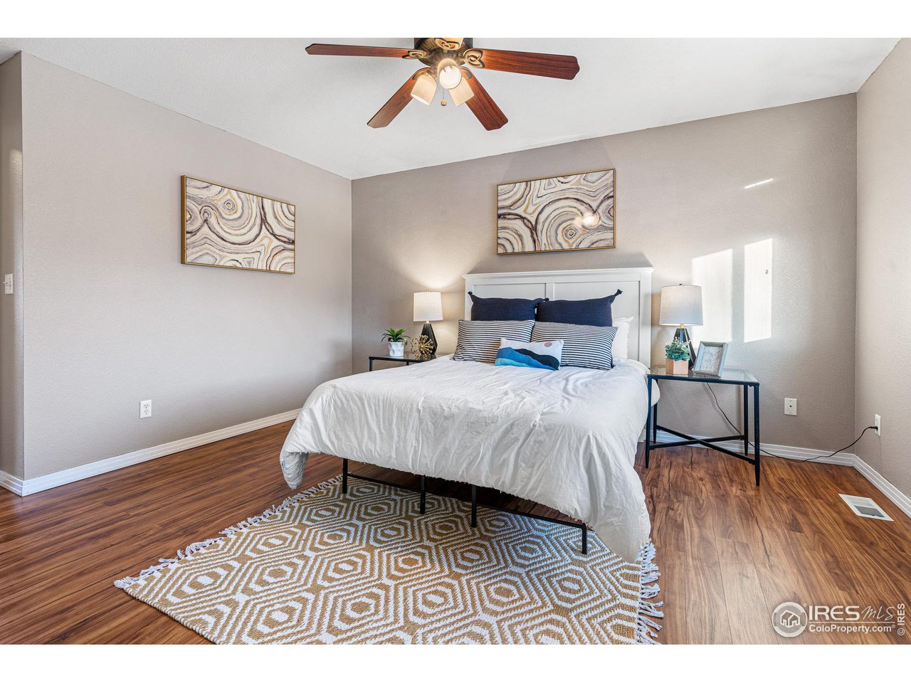 628 Sumac Street Frederick, CO 80530 - Photo 21 of 38 a bedroom with a bed and a chandelier