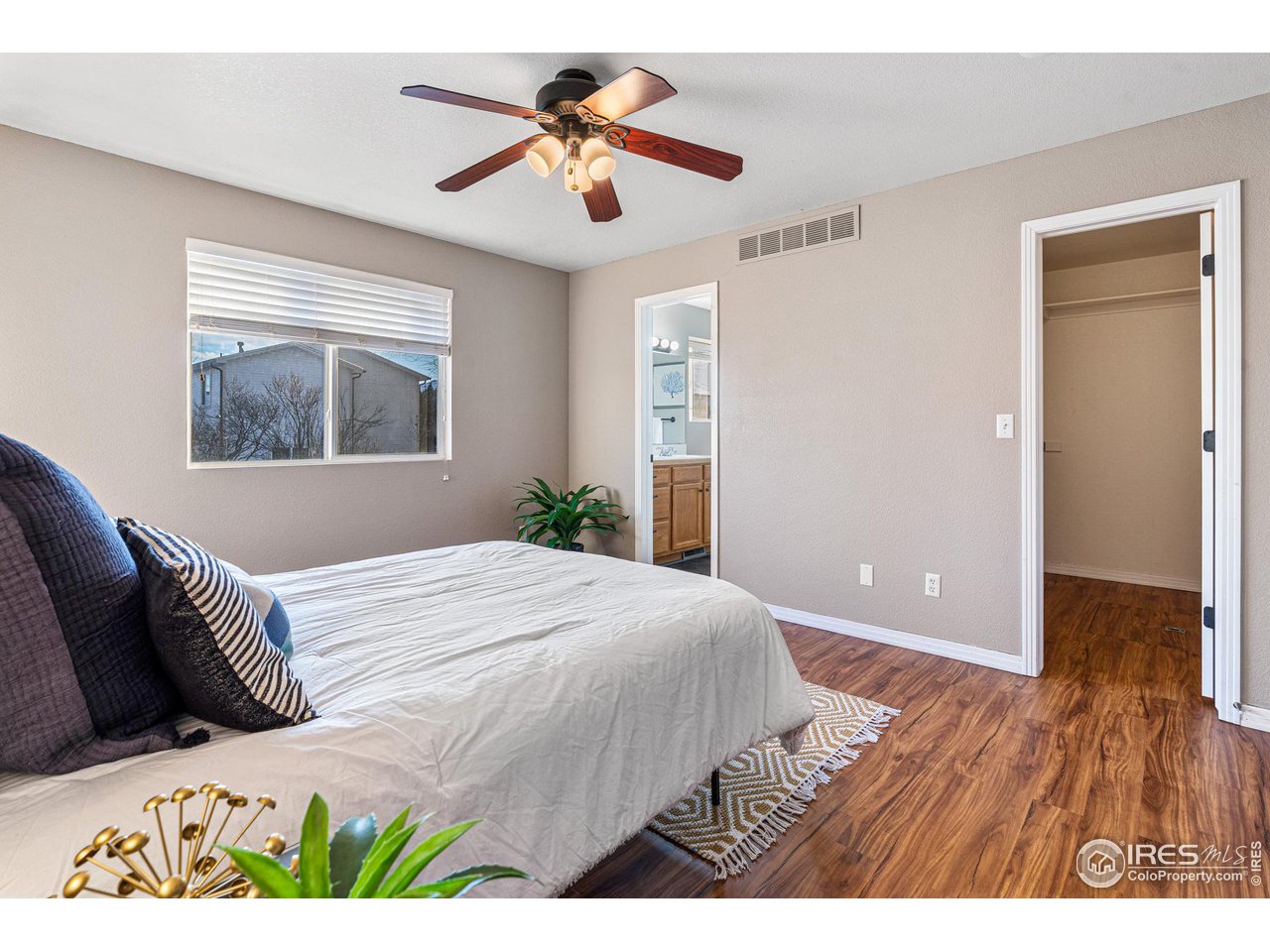 628 Sumac Street Frederick, CO 80530 - Photo 22 of 38 a bedroom with a bed and a painting on the wall