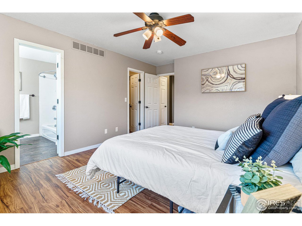 628 Sumac Street Frederick, CO 80530 - Photo 23 of 38 a bedroom with a bed and a chandelier