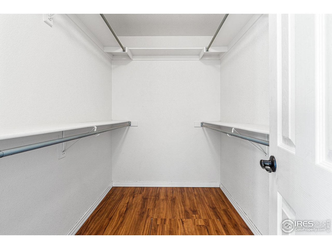 628 Sumac Street Frederick, CO 80530 - Photo 26 of 38 a picture of door and utility room with wooden floor