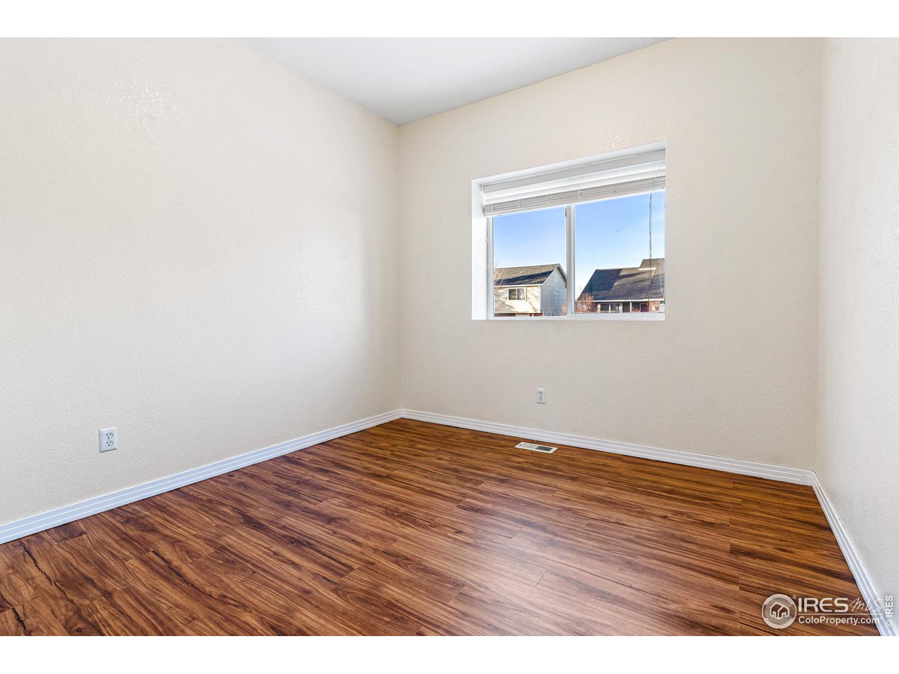 628 Sumac Street Frederick, CO 80530 - Photo 27 of 38 a view of an empty room with wooden floor and a window