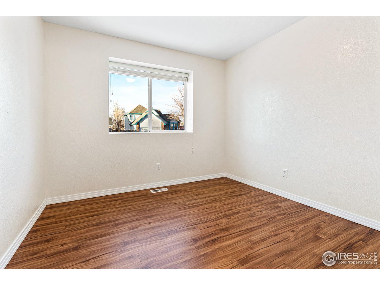 628 Sumac Street Frederick, CO 80530 - Photo 28 of 38 an empty room with wooden floor and window