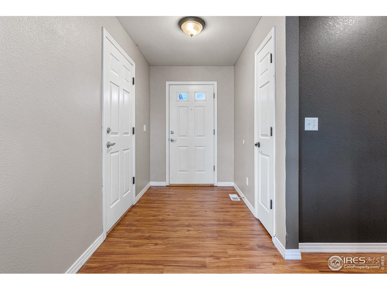 628 Sumac Street Frederick, CO 80530 - Photo 5 of 38 a view of a hallway with wooden floor