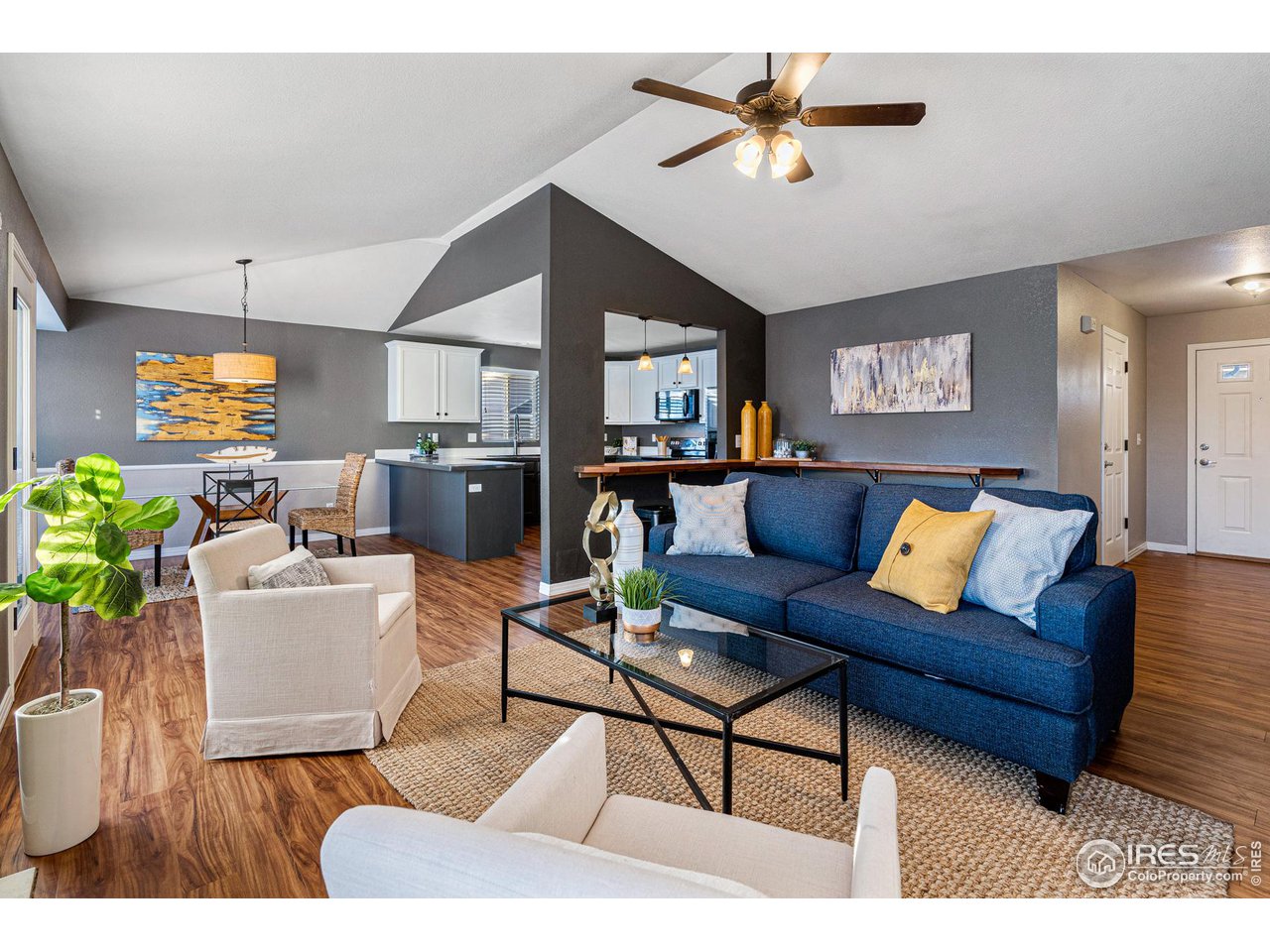 628 Sumac Street Frederick, CO 80530 - Photo 10 of 38 a living room with furniture a chandelier and a dining table