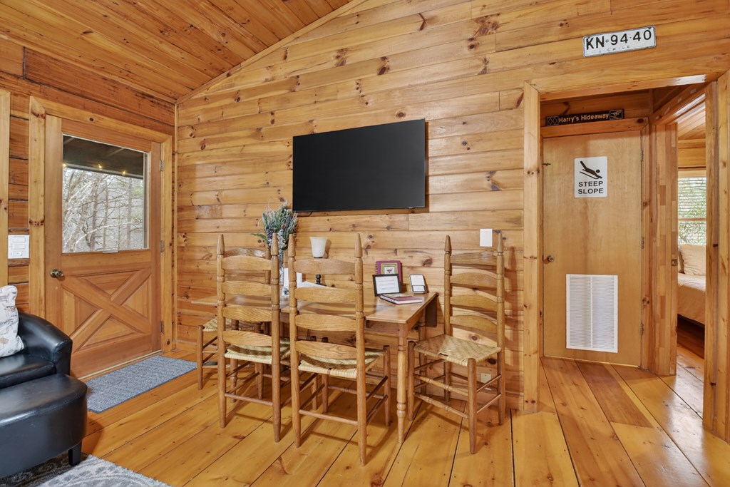 488 Joann Sisson Road Blue Ridge, GA 30513 - Photo 19 of 39 a living room with a wooden floor and a flat screen tv