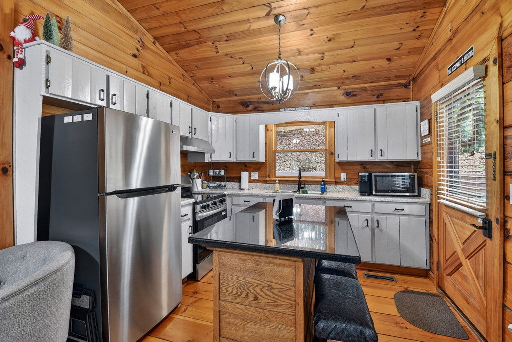 488 Joann Sisson Road Blue Ridge, GA 30513 - Photo 20 of 39 a kitchen with refrigerator cabinets and wooden floor
