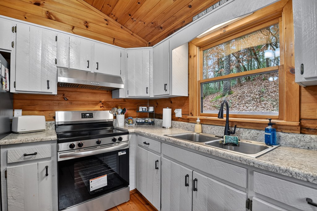 488 Joann Sisson Road Blue Ridge, GA 30513 - Photo 22 of 39 a kitchen with stainless steel appliances granite countertop a sink stove and window