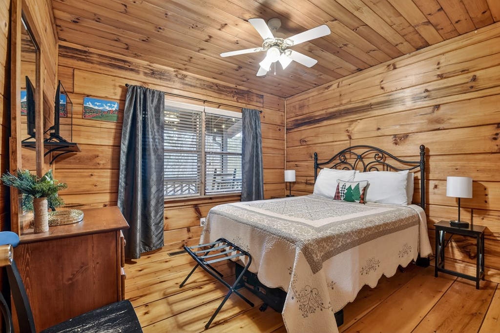 488 Joann Sisson Road Blue Ridge, GA 30513 - Photo 26 of 39 a bedroom with a bed and wooden floor