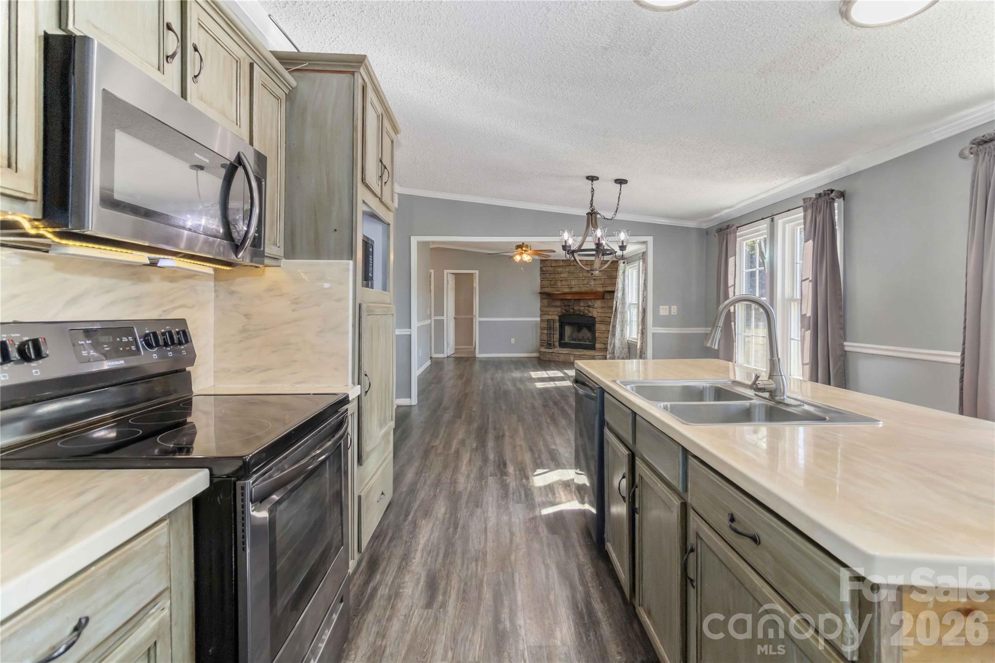 482 Pine Road Jefferson, SC 29718 - Photo 16 of 39 a kitchen with granite countertop a sink stove and refrigerator