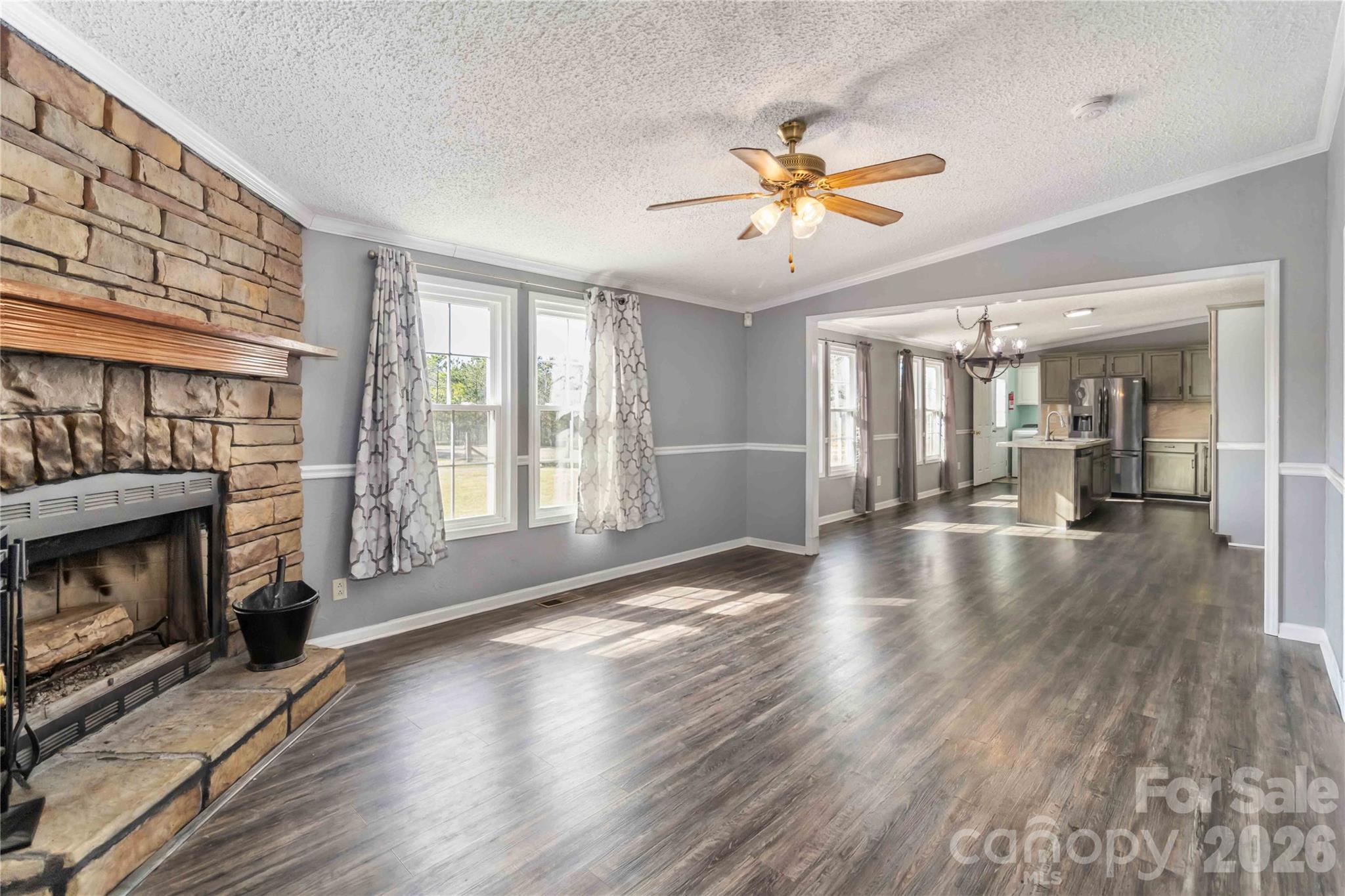 482 Pine Road Jefferson, SC 29718 - Photo 20 of 39 a view of an empty room with wooden floor fireplace and a window