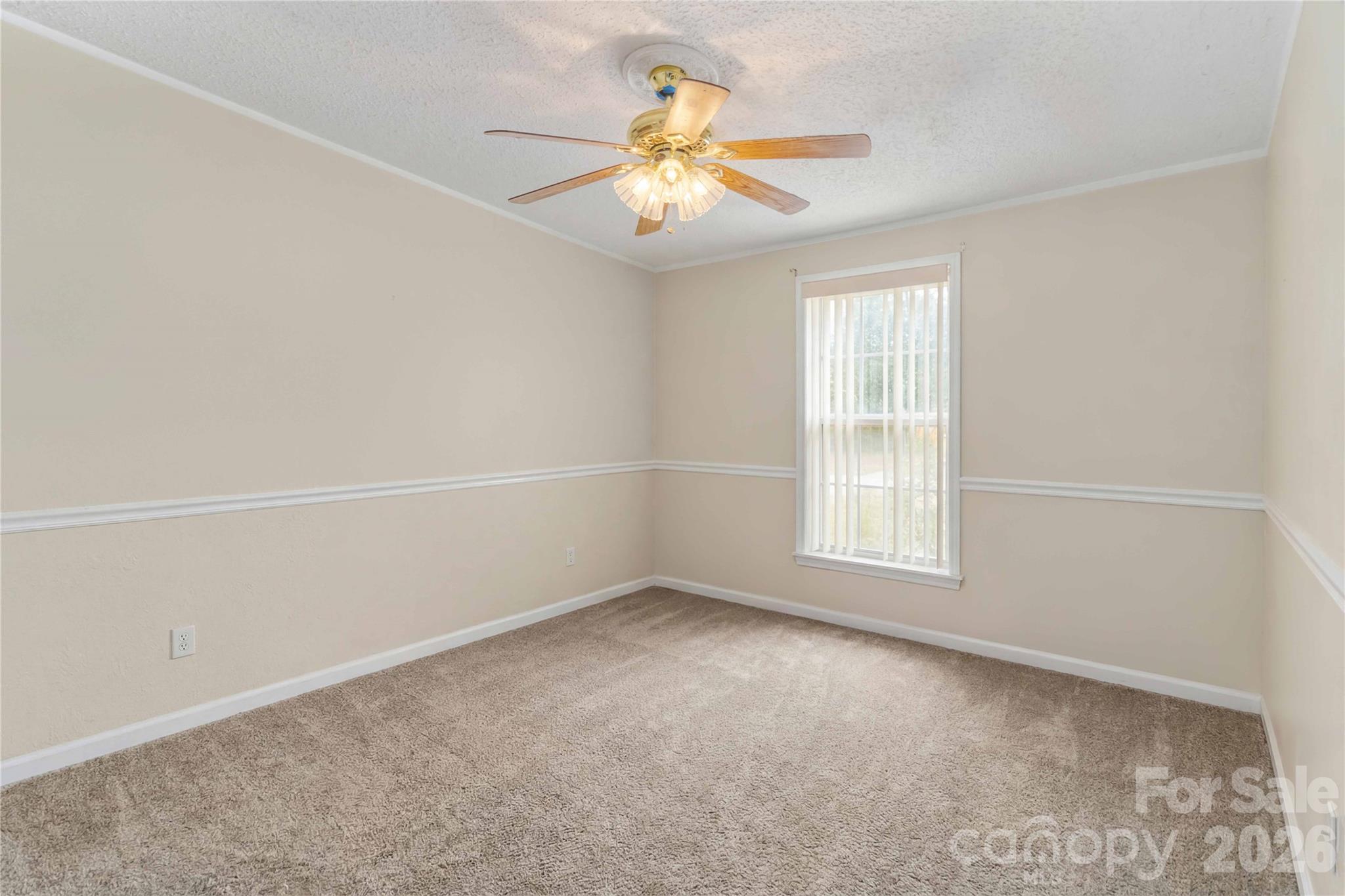 482 Pine Road Jefferson, SC 29718 - Photo 25 of 39 an empty room with a window and a fan
