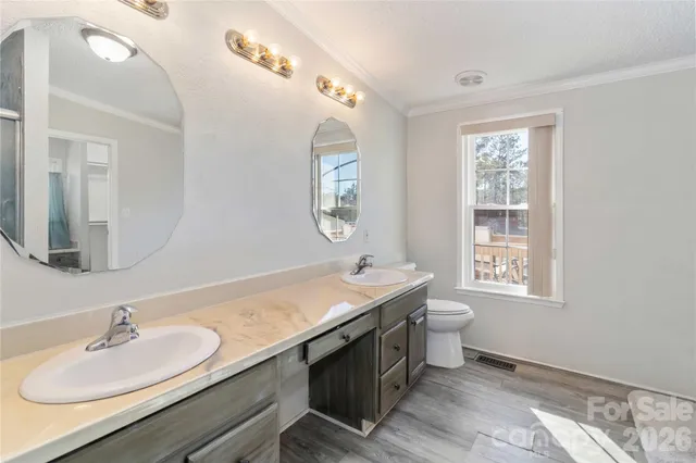 a bathroom with a double vanity sink and a mirror