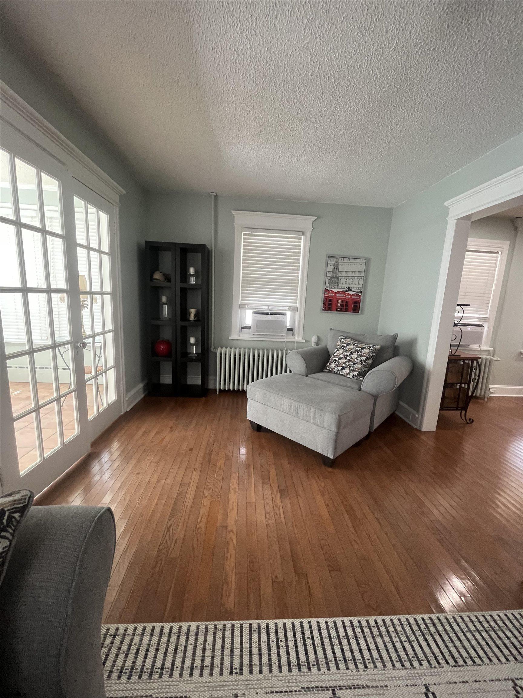 15 North Melbourne Avenue, Unit WINTER 2025 Ventnor City, NJ 08406 - Photo 4 of 15 a living room with furniture and a wooden floor