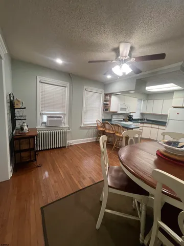 a kitchen with kitchen island a stove a table and chairs in it