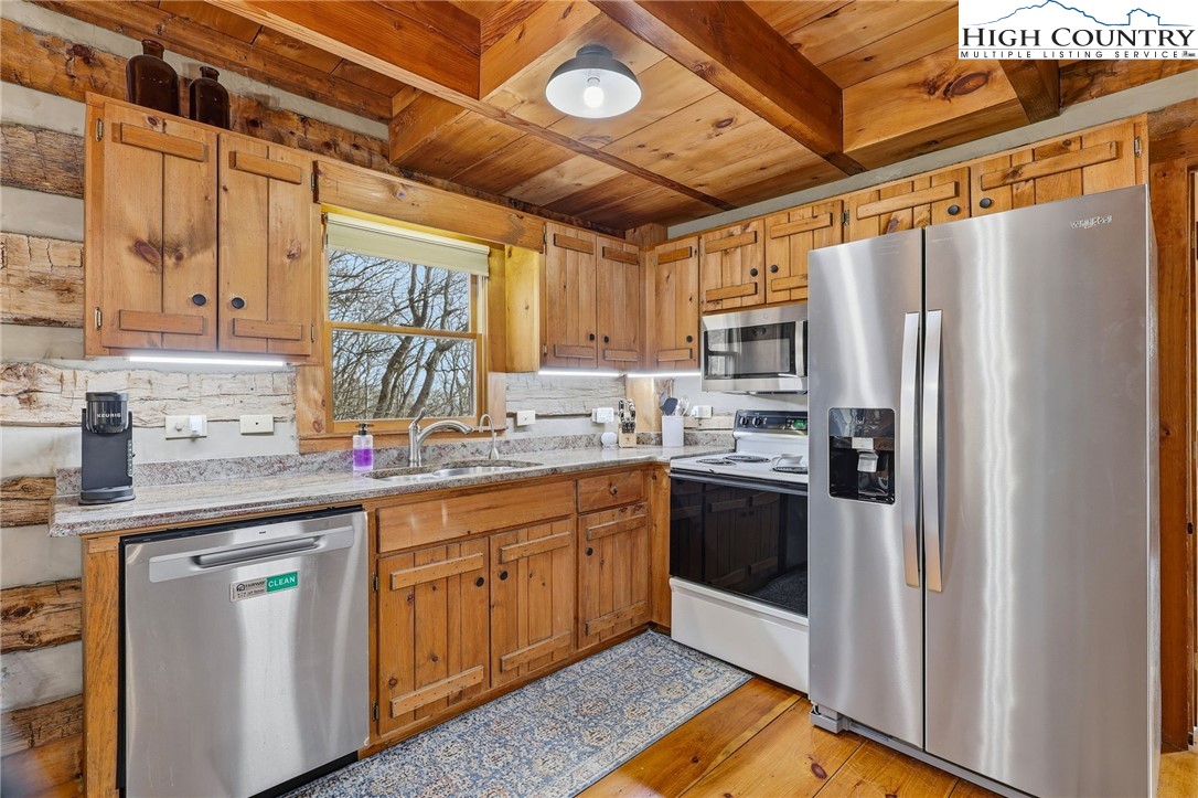 1411 Homestead Road Todd, NC 28684 - Photo 12 of 42 a kitchen with stainless steel appliances granite countertop a refrigerator and a sink