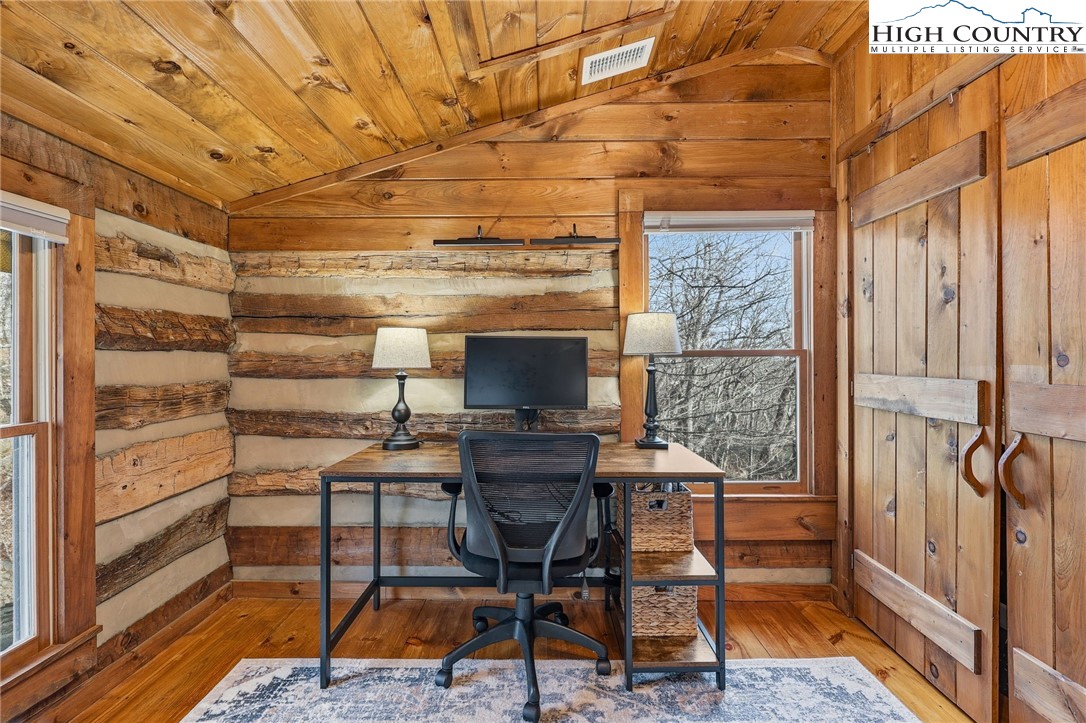 1411 Homestead Road Todd, NC 28684 - Photo 16 of 42 a workspace with furniture and a fireplace