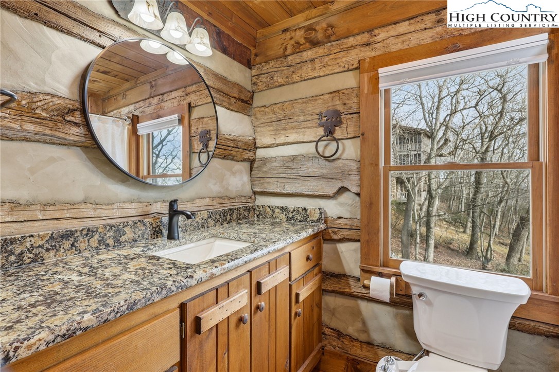 1411 Homestead Road Todd, NC 28684 - Photo 20 of 42 a bathroom with a granite countertop sink and a mirror