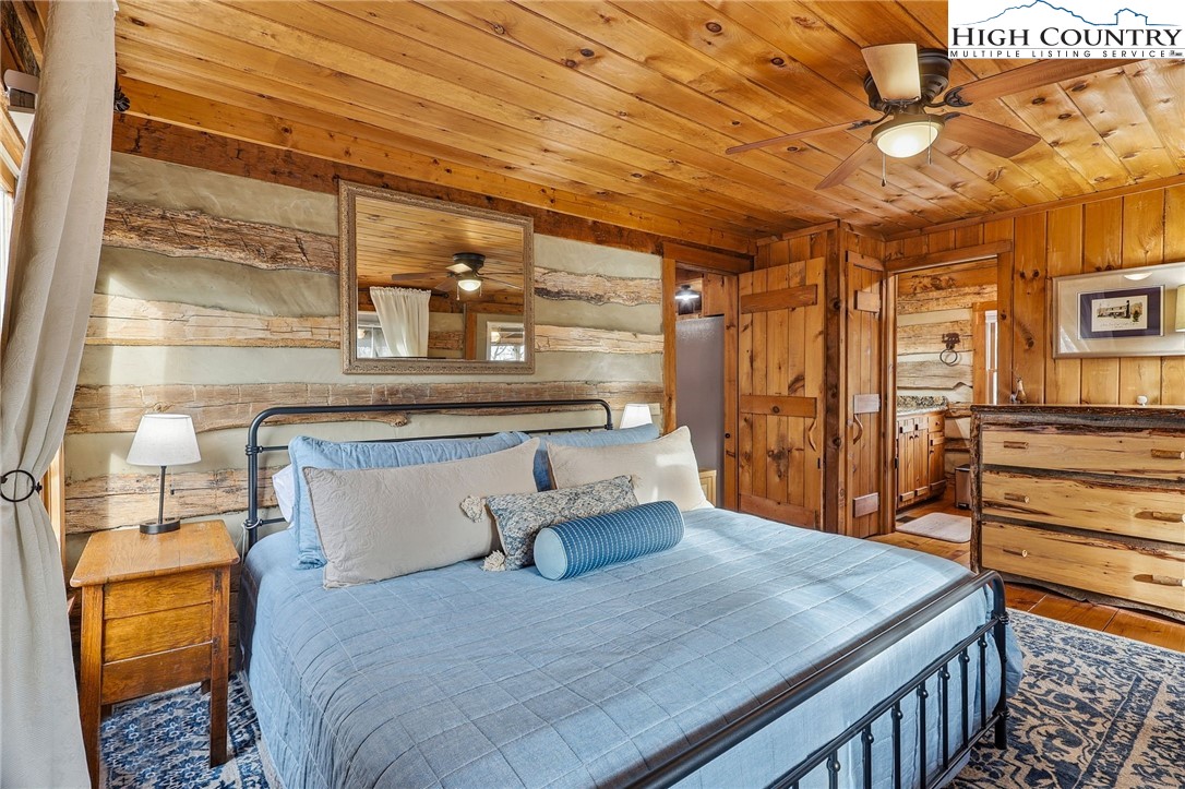 1411 Homestead Road Todd, NC 28684 - Photo 22 of 42 a bedroom with a bed and wooden floor