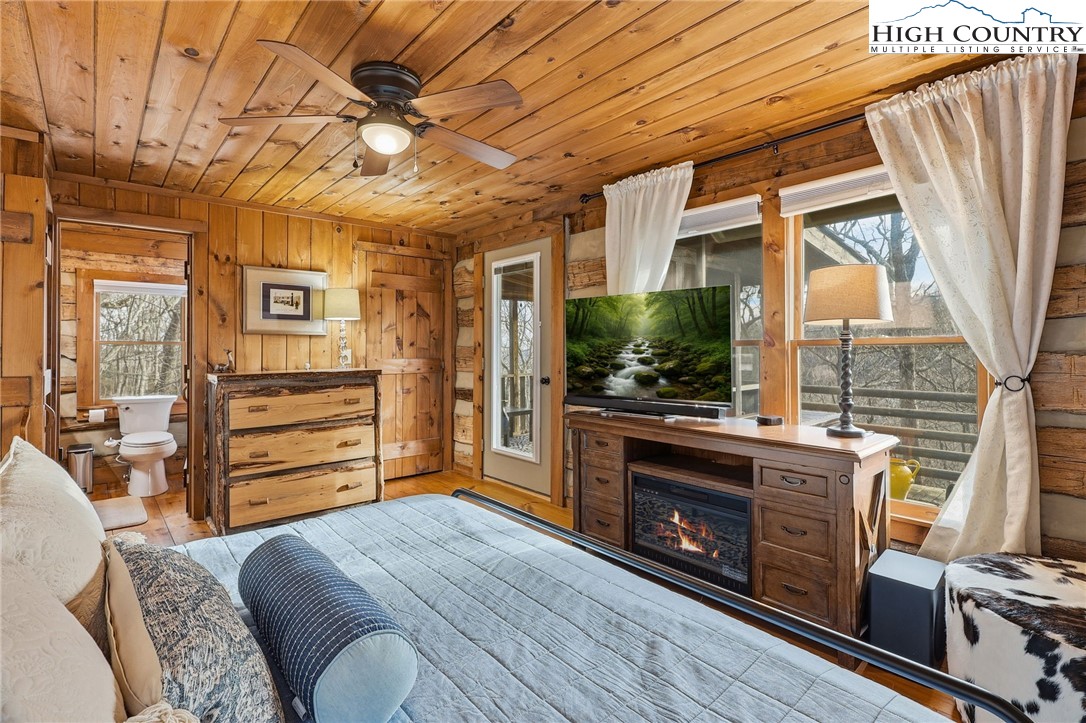 1411 Homestead Road Todd, NC 28684 - Photo 23 of 42 a bedroom with furniture and a flat screen tv