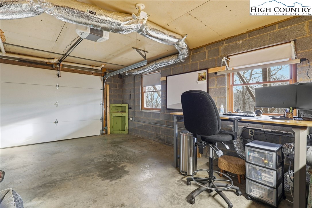1411 Homestead Road Todd, NC 28684 - Photo 40 of 42 a view of a workspace with furniture and a window