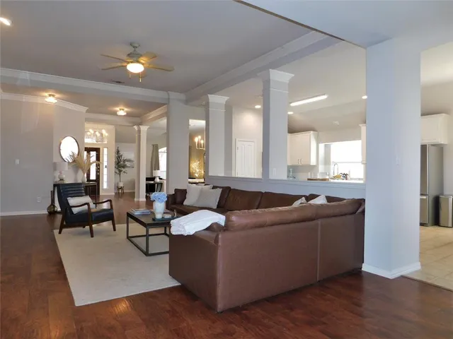 a living room with furniture and a wooden floor