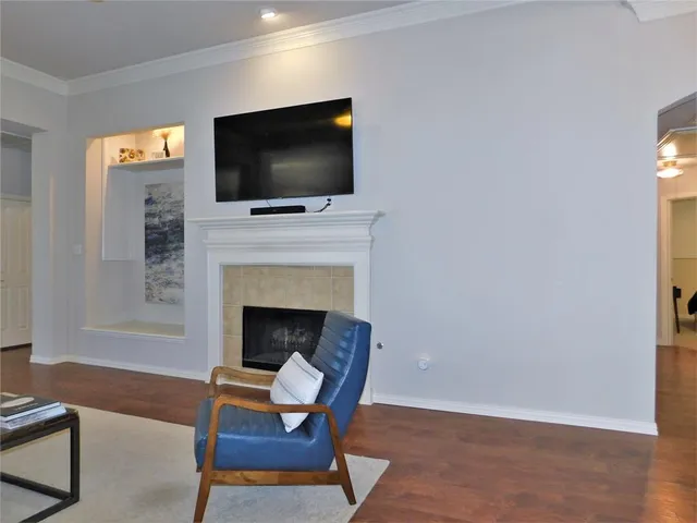 a living room with a fireplace and a flat screen tv