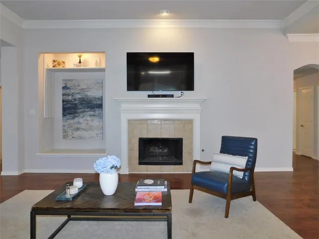 a living room with furniture a flat screen tv and a fireplace