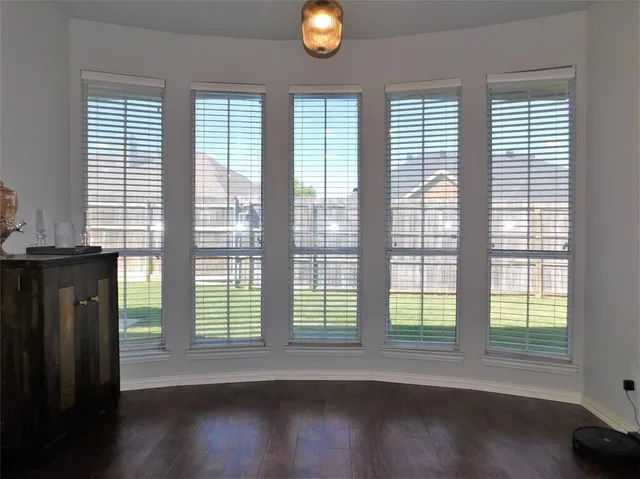 a view of wooden floor and windows in an empty room