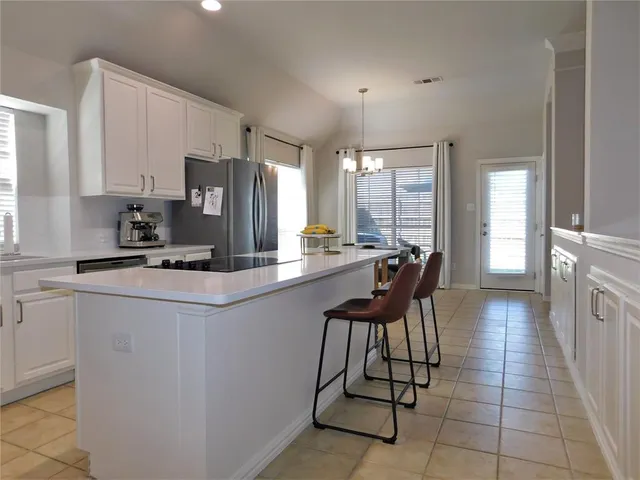 a kitchen with stainless steel appliances a sink counter space and a window