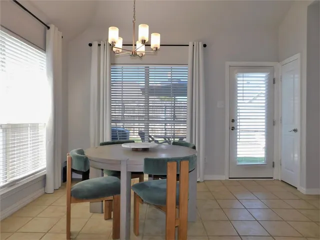 a view of a dining room with furniture and window