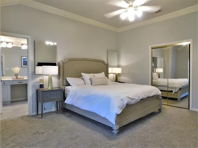 a bedroom with a bed and a mirror