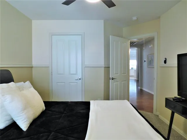 a bedroom with a bed and a mirror