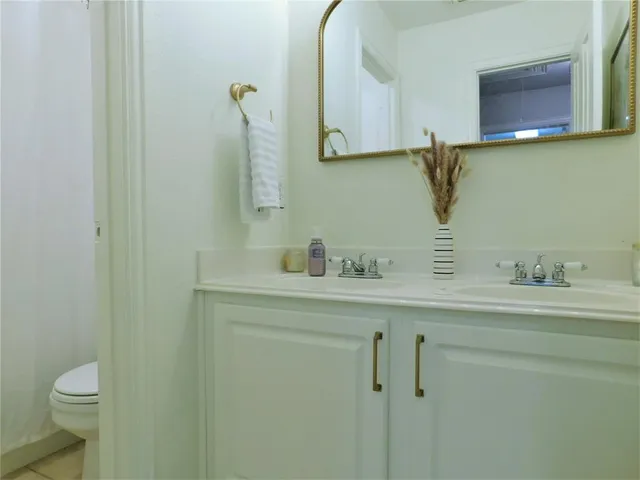 a bathroom with a sink a toilet and mirror