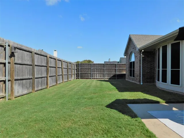 a view of backyard with seating space
