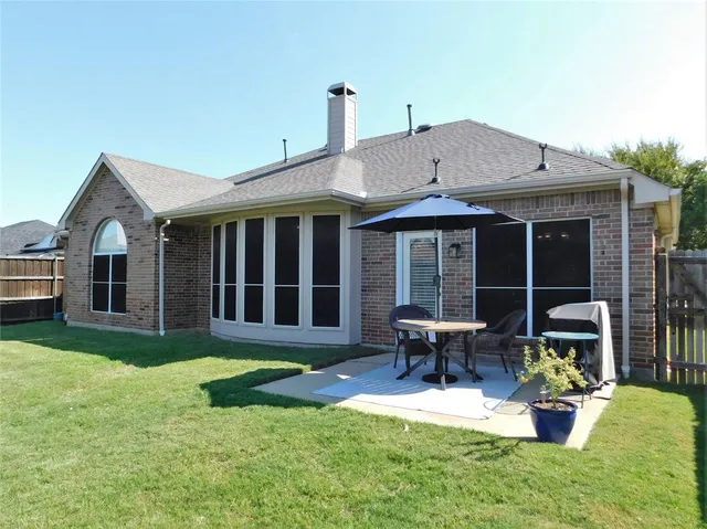 a view of a house with a yard and sitting area
