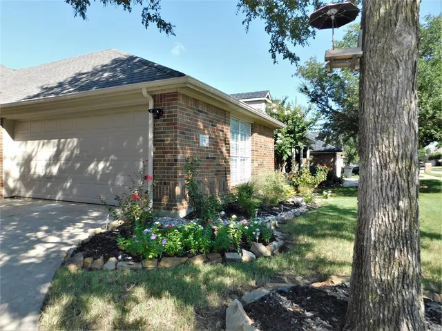 a view of a pathway of a house with a yard