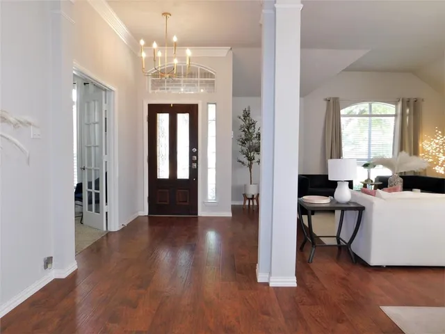a view of a livingroom with furniture window and wooden floor