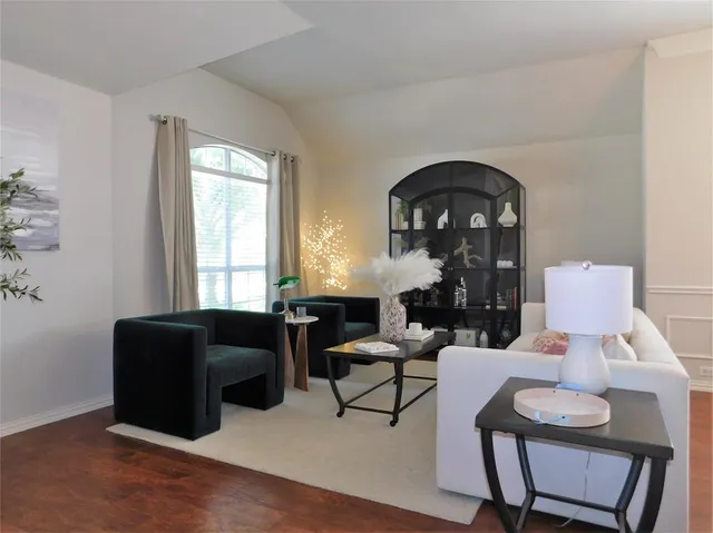 a living room with furniture and a potted plant