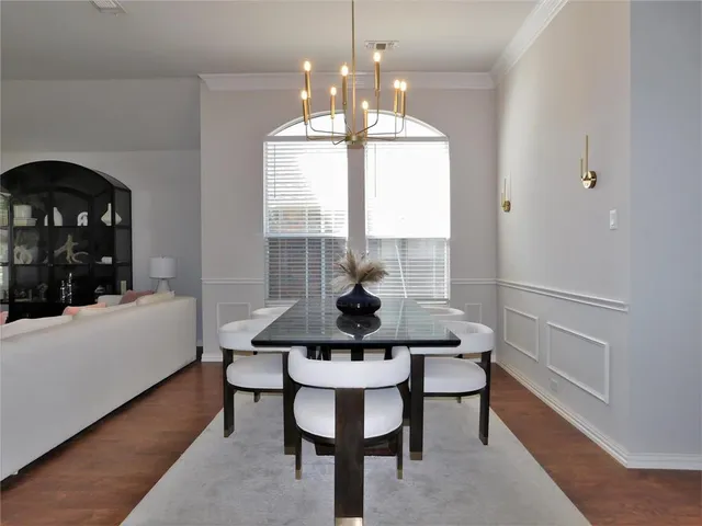 a view of a dining room with furniture and chandelier